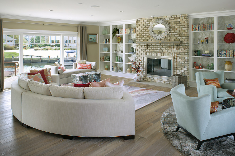 Large coastal open plan living room in Other with beige walls, a standard fireplace and a brick fireplace surround.