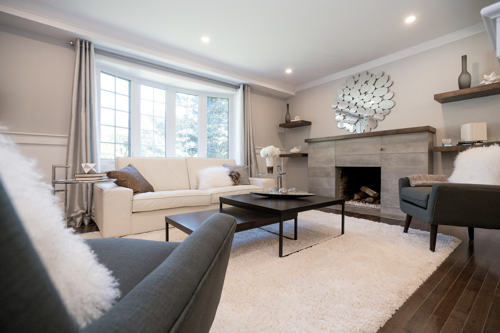 Design ideas for a medium sized contemporary open plan living room in Montreal with grey walls, dark hardwood flooring, a standard fireplace, a stone fireplace surround and brown floors.