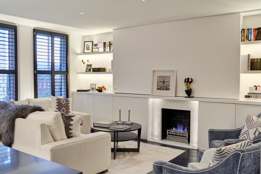 Example of a small trendy formal and open concept dark wood floor living room design in London with white walls, a standard fireplace and a tile fireplace