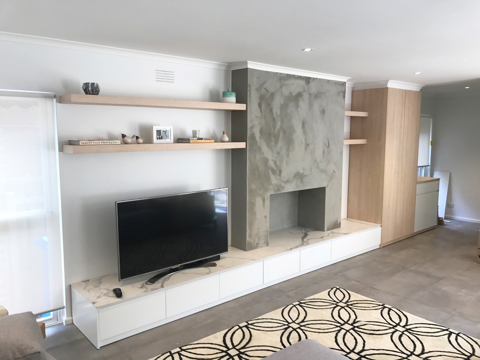 Inspiration for a medium sized modern formal open plan living room in Melbourne with white walls, slate flooring, a wood burning stove, a concrete fireplace surround, a freestanding tv and grey floors.