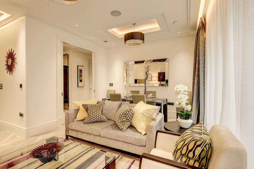 This is an example of a medium sized classic formal enclosed living room in London with white walls, light hardwood flooring, no fireplace and no tv.