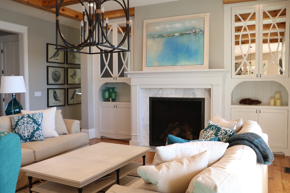 Living room - large country open concept medium tone wood floor living room idea in Other with gray walls, a standard fireplace, a wood fireplace surround and a media wall