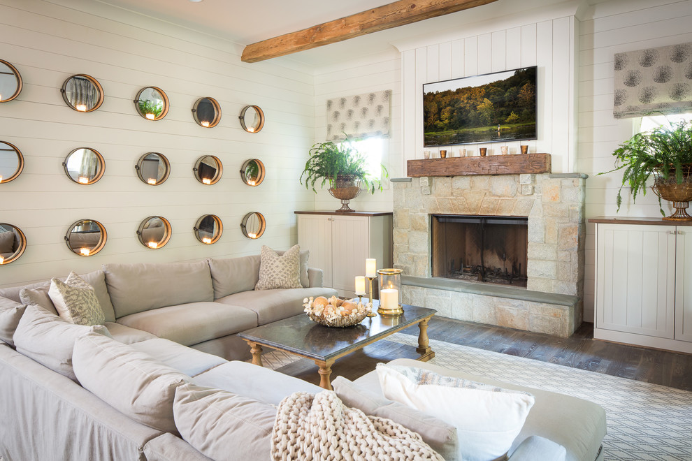 This is an example of a large rural open plan living room in Atlanta with white walls, medium hardwood flooring, a standard fireplace, a stone fireplace surround and a wall mounted tv.