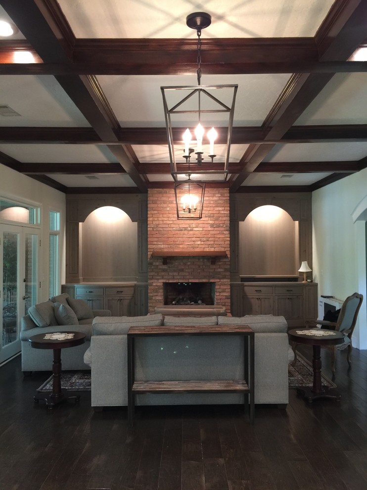 Inspiration for a mid-sized timeless open concept dark wood floor living room remodel in Atlanta with beige walls, a standard fireplace, a brick fireplace and no tv