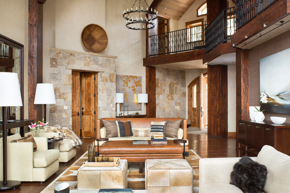 Example of a mountain style formal and open concept dark wood floor living room design in Denver with beige walls and no fireplace