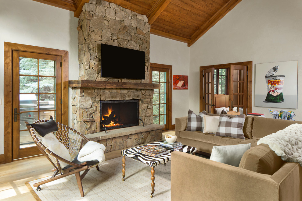 Inspiration for a rustic light wood floor living room remodel in Denver with white walls, a standard fireplace and a wall-mounted tv