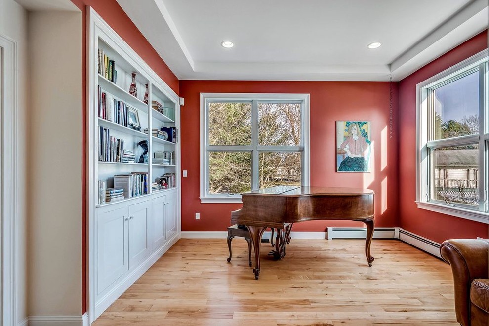 Example of a small trendy enclosed light wood floor and yellow floor living room design in Boston with a music area and red walls