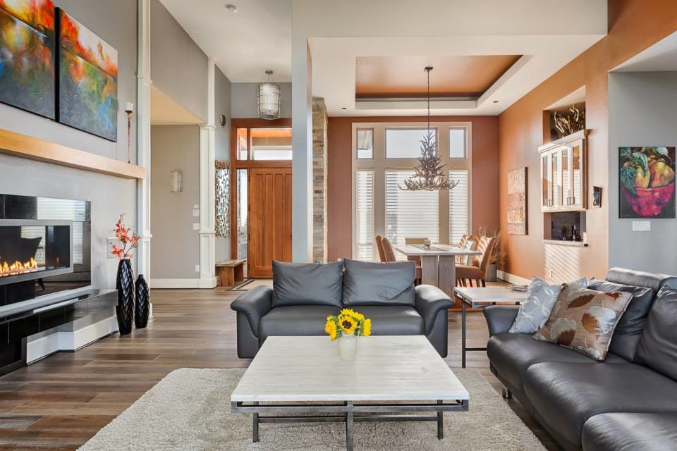 Inspiration for an expansive contemporary open plan living room in Portland with grey walls, medium hardwood flooring, a ribbon fireplace, a tiled fireplace surround and a wall mounted tv.