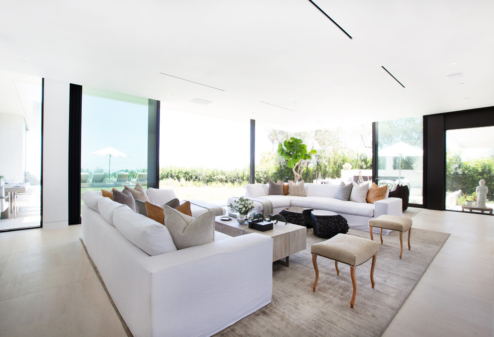 Inspiration for an expansive contemporary formal open plan living room in Los Angeles with white walls, limestone flooring, a two-sided fireplace, a tiled fireplace surround and a wall mounted tv.