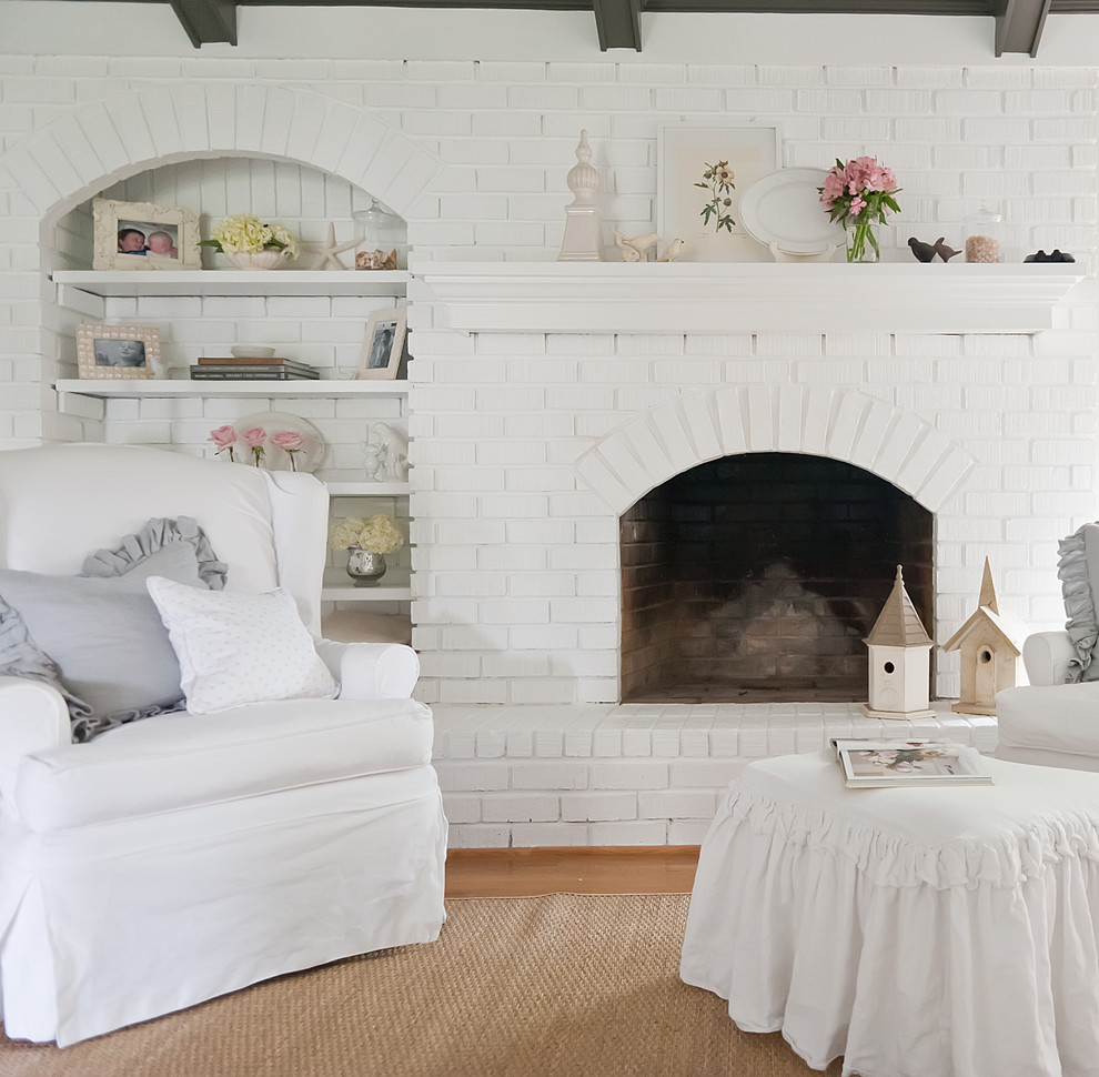Example of a cottage chic living room design in Nashville with a brick fireplace
