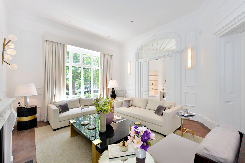 Abgetrenntes Klassisches Wohnzimmer mit weißer Wandfarbe, braunem Holzboden, Kamin, braunem Boden und Kaminumrandung aus Stein in London