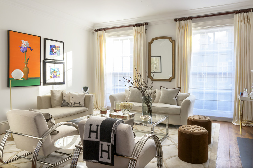 This is an example of a medium sized classic living room in London with beige walls, medium hardwood flooring and brown floors.