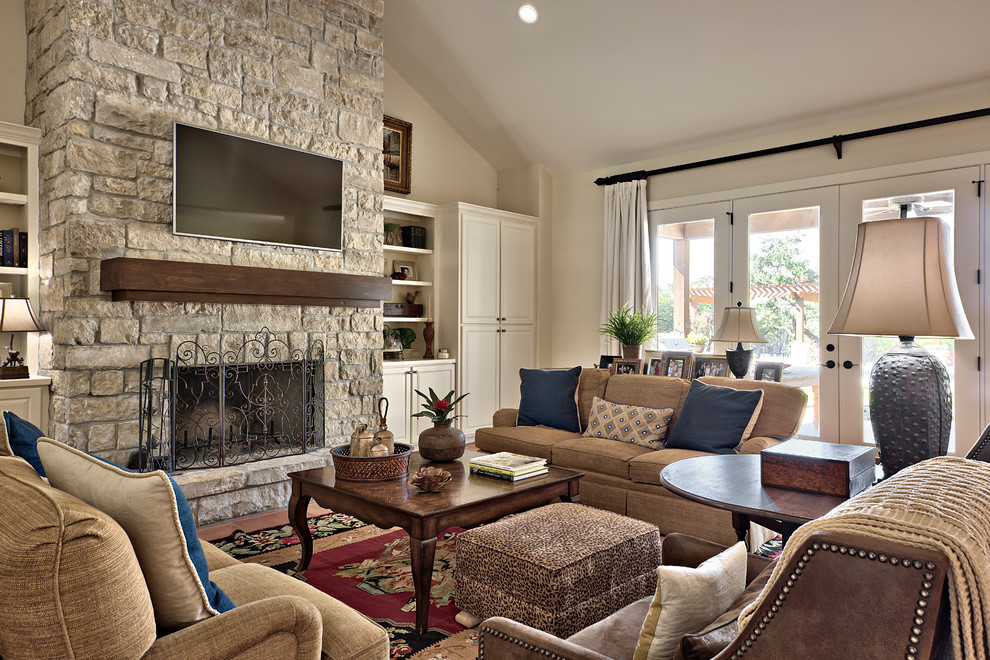 Design ideas for a large classic open plan living room in Austin with beige walls, a standard fireplace, a stone fireplace surround and a wall mounted tv.