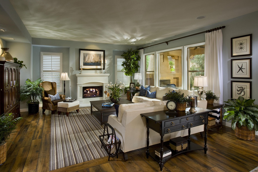Living room - large traditional formal and open concept dark wood floor and multicolored floor living room idea in Las Vegas with blue walls, a standard fireplace and a plaster fireplace