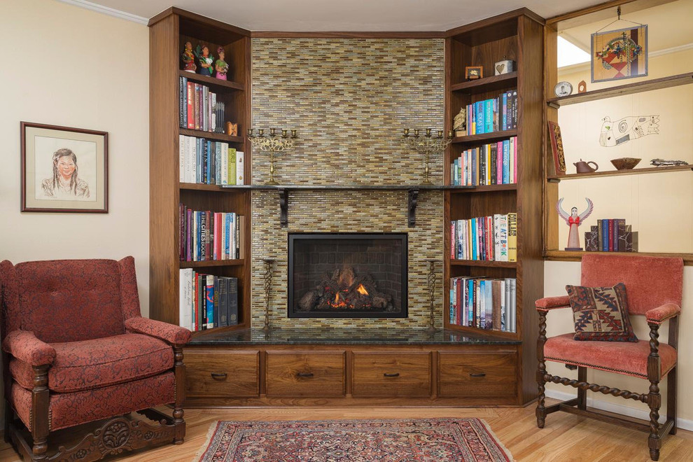 Inspiration for a large rustic open concept light wood floor and brown floor living room library remodel in San Francisco with beige walls, a standard fireplace and a tile fireplace