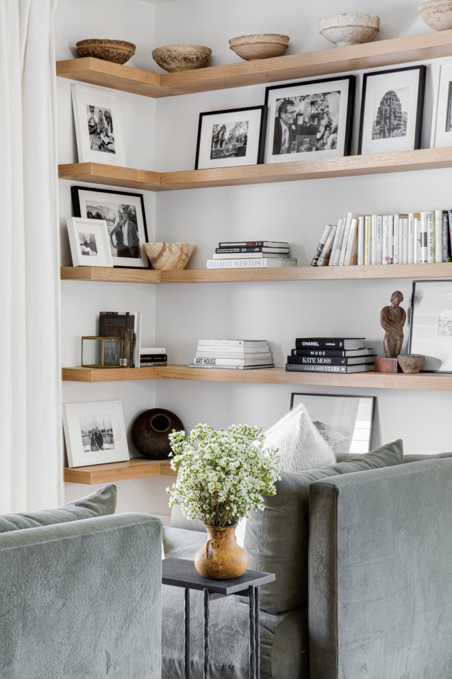 This is an example of a large scandi open plan living room in San Diego with a reading nook, white walls, light hardwood flooring and beige floors.