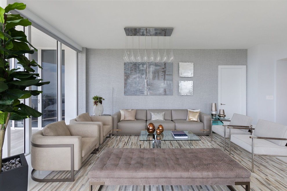 This is an example of a contemporary formal open plan living room in Miami with grey walls and no fireplace.
