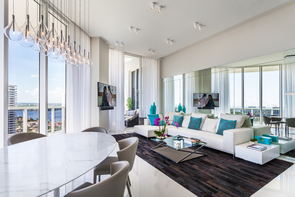Идея дизайна: большая гостиная комната в современном стиле с серыми стенами, полом из керамической плитки и телевизором на стене