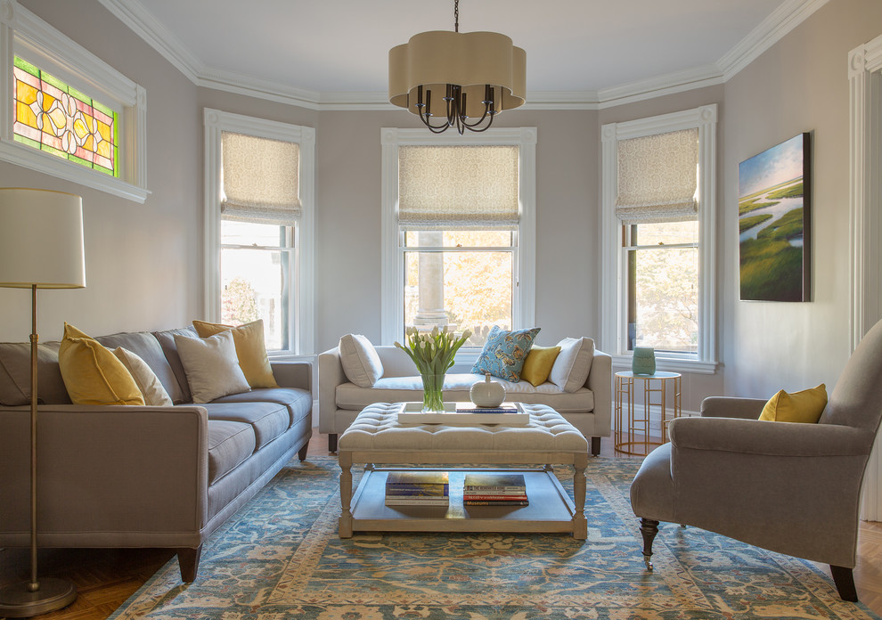 Medium sized victorian formal enclosed living room in Boston with grey walls, medium hardwood flooring and feature lighting.
