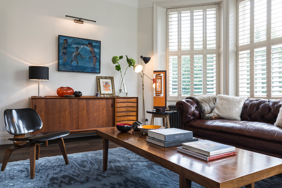 Inspiration for a 1950s formal dark wood floor living room remodel in London with white walls