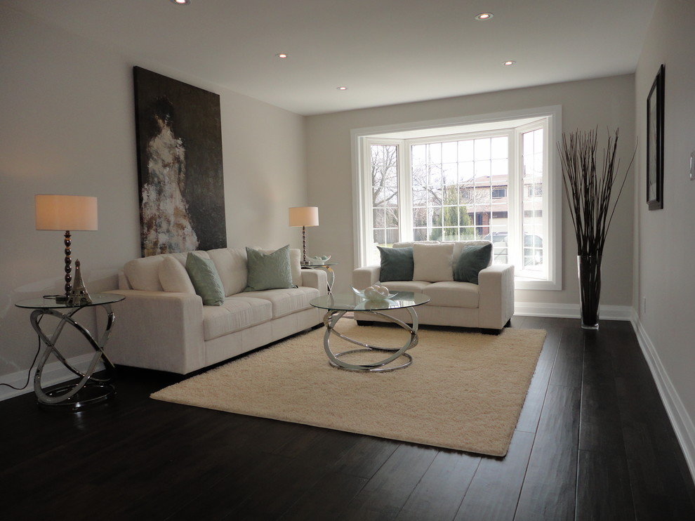 Inspiration for a large contemporary formal and open concept dark wood floor living room remodel in Toronto with white walls