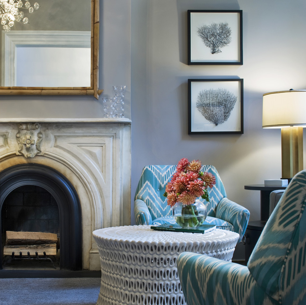 Inspiration for a contemporary grey and teal living room in New York with blue walls and a standard fireplace.