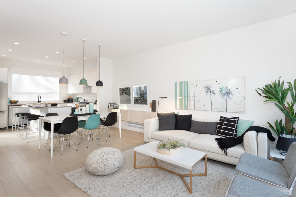 Ispirazione per un soggiorno scandinavo di medie dimensioni e aperto con pareti bianche, pavimento in laminato e pavimento beige