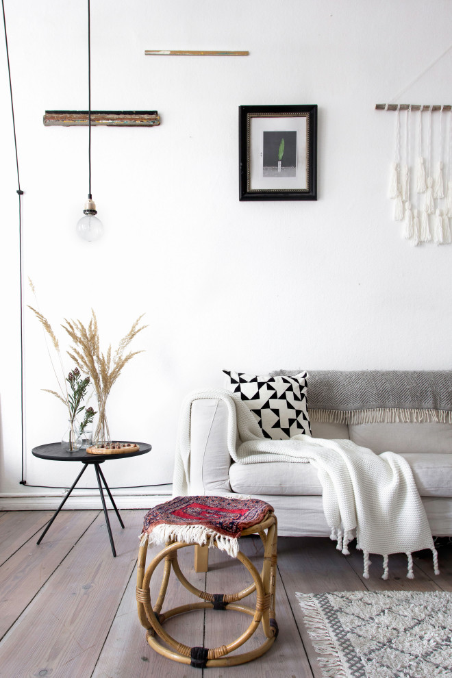 Inspiration for a medium sized scandi living room in Berlin with white walls, light hardwood flooring and beige floors.