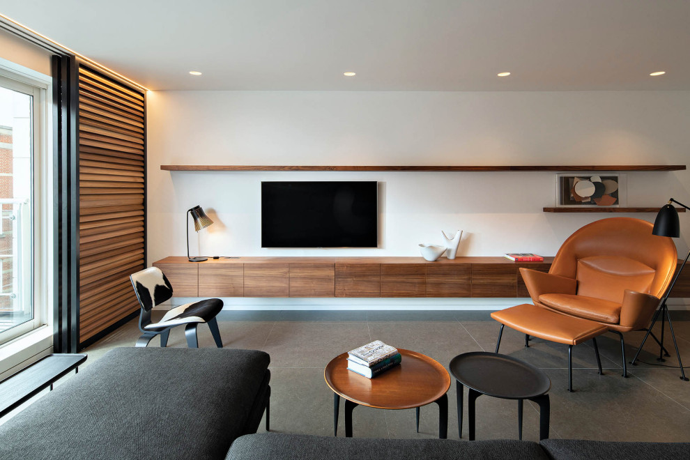 Diseño de salón abierto moderno sin chimenea con paredes blancas, televisor colgado en la pared y suelo gris