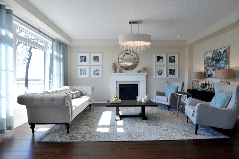 Inspiration for a large traditional formal enclosed living room in Toronto with beige walls, dark hardwood flooring, a standard fireplace, a plastered fireplace surround and no tv.