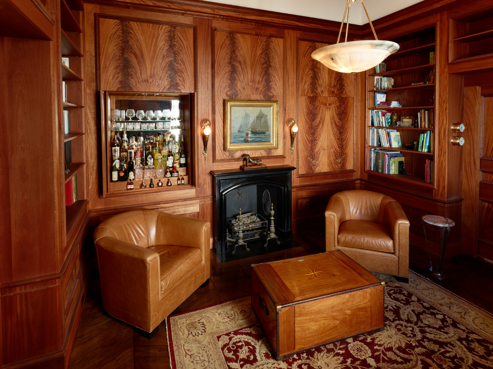 Example of a small ornate enclosed dark wood floor and brown floor living room library design in Boston with brown walls, a wood stove, a metal fireplace and no tv