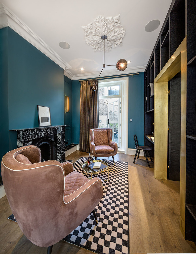 This is an example of a medium sized contemporary enclosed living room in London with a reading nook, blue walls, medium hardwood flooring, a wood burning stove, a stone fireplace surround and no tv.