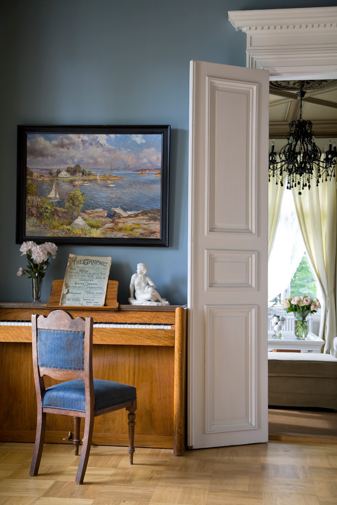 Inspiration for a timeless enclosed medium tone wood floor living room remodel in Other with blue walls