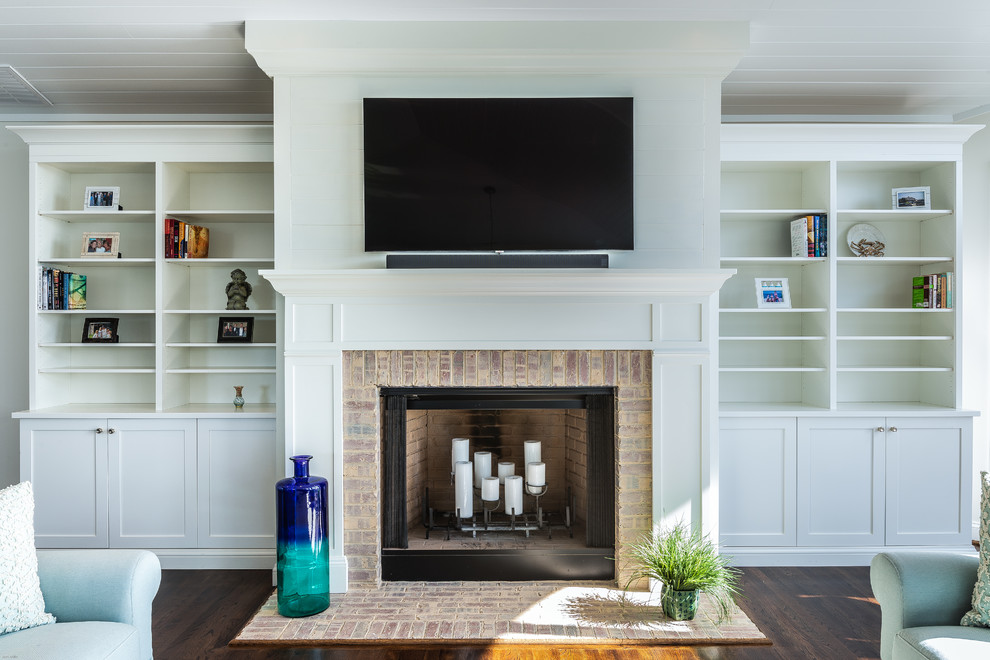 Inspiration for a large coastal formal and open concept laminate floor and brown floor living room remodel in DC Metro with white walls, a standard fireplace, a brick fireplace and a wall-mounted tv