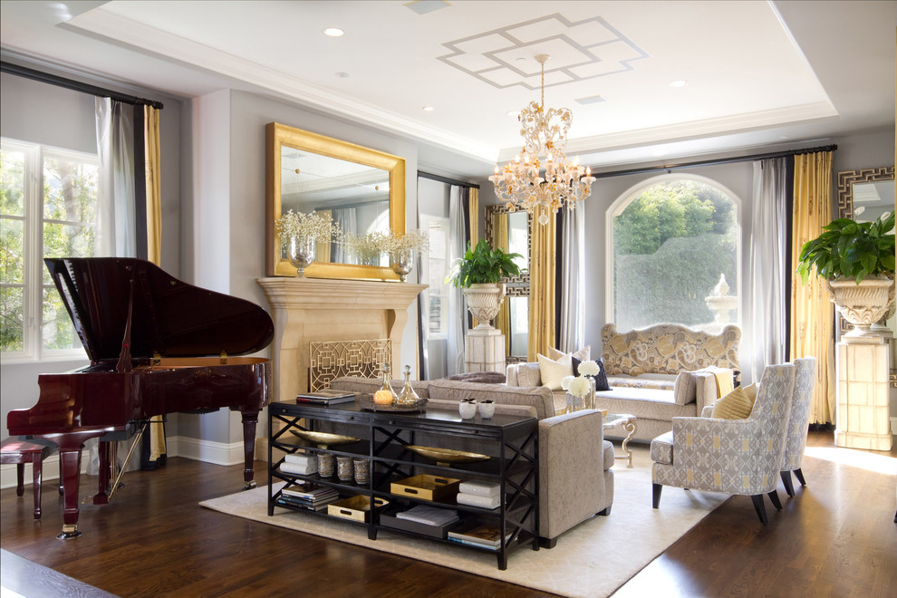 Example of a classic living room design in Los Angeles with a music area, gray walls and a standard fireplace