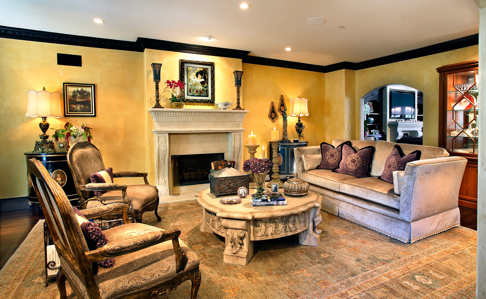 Living room - large mediterranean formal and enclosed dark wood floor living room idea in Los Angeles with yellow walls, a standard fireplace and a stone fireplace
