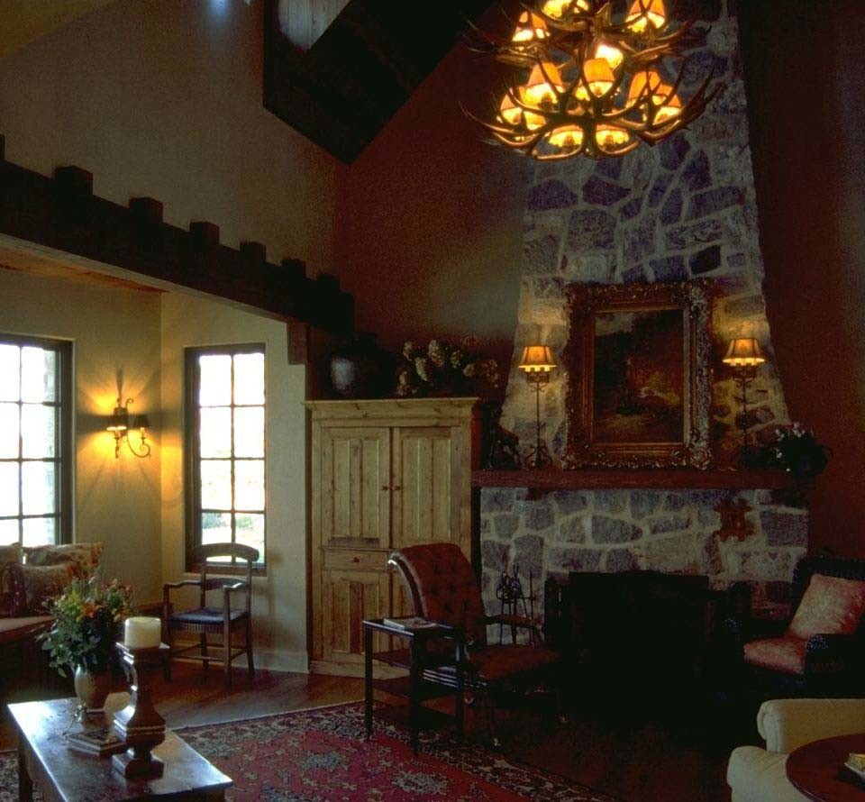 Example of a classic open concept dark wood floor living room design in Minneapolis with yellow walls, a standard fireplace and a stone fireplace