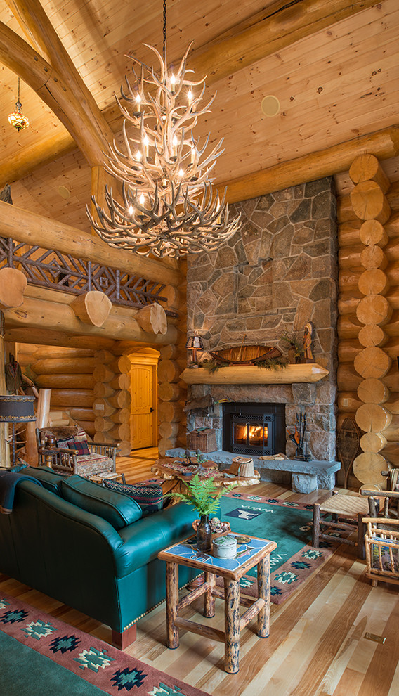 Example of a mountain style medium tone wood floor living room design in New York with a standard fireplace and a stone fireplace