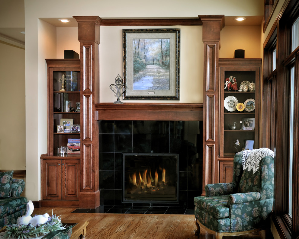 This is an example of a traditional living room in Kansas City with a standard fireplace and a tiled fireplace surround.