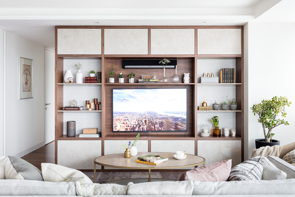 Esempio di un soggiorno minimal con pareti bianche, pavimento in legno massello medio, TV a parete e pavimento marrone