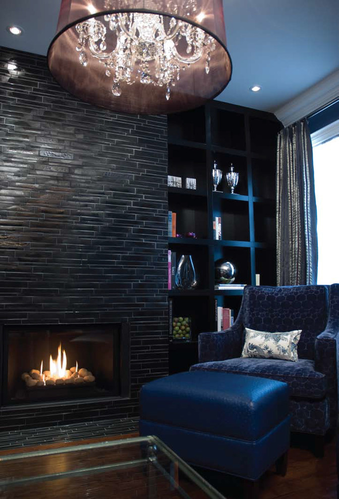 Example of an eclectic living room library design in Toronto with black walls, a standard fireplace and a tile fireplace