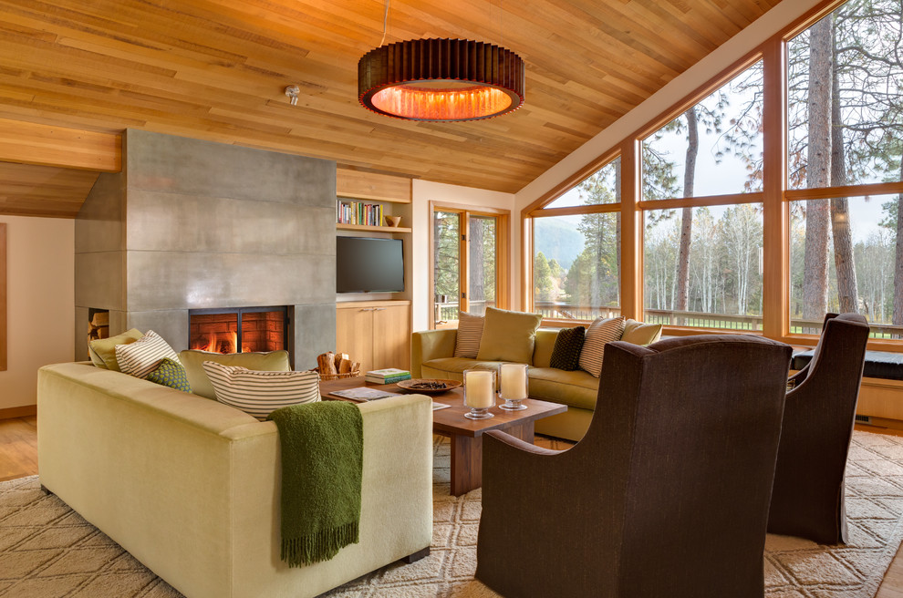 This is an example of a traditional living room in Portland with a concrete fireplace surround.