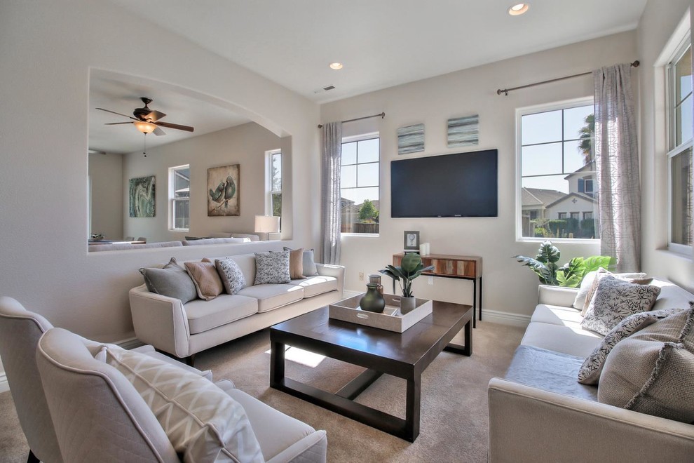 Medium sized contemporary enclosed living room in Other with beige walls, carpet and a wall mounted tv.