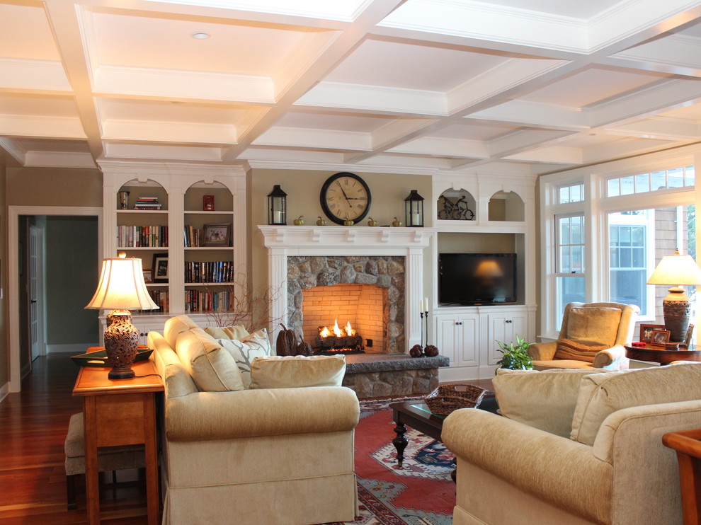 Large elegant open concept medium tone wood floor living room photo in Portland Maine with beige walls, a standard fireplace, a stone fireplace and a media wall