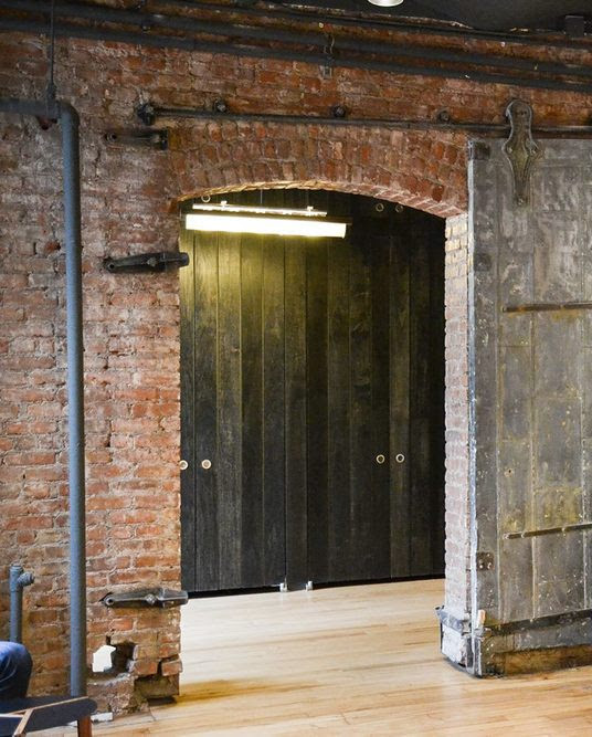 Inspiration for a mid-sized industrial light wood floor and gray floor living room remodel in New York with red walls and no fireplace