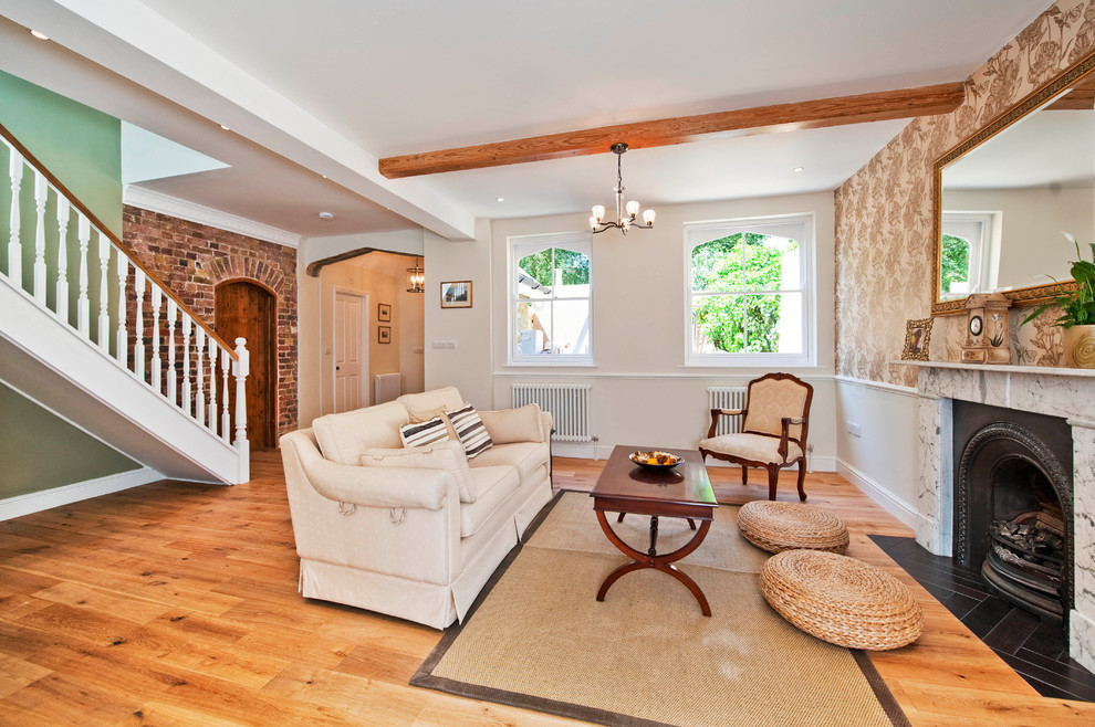 Design ideas for a traditional living room in London with medium hardwood flooring and a standard fireplace.