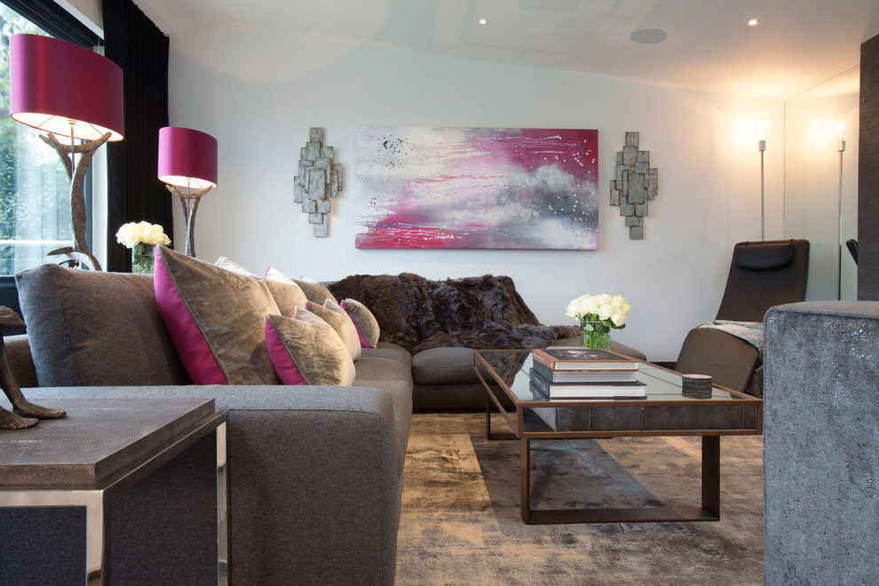 This is an example of a medium sized contemporary open plan living room in Surrey with white walls, a metal fireplace surround, a wall mounted tv, porcelain flooring, a ribbon fireplace and black floors.