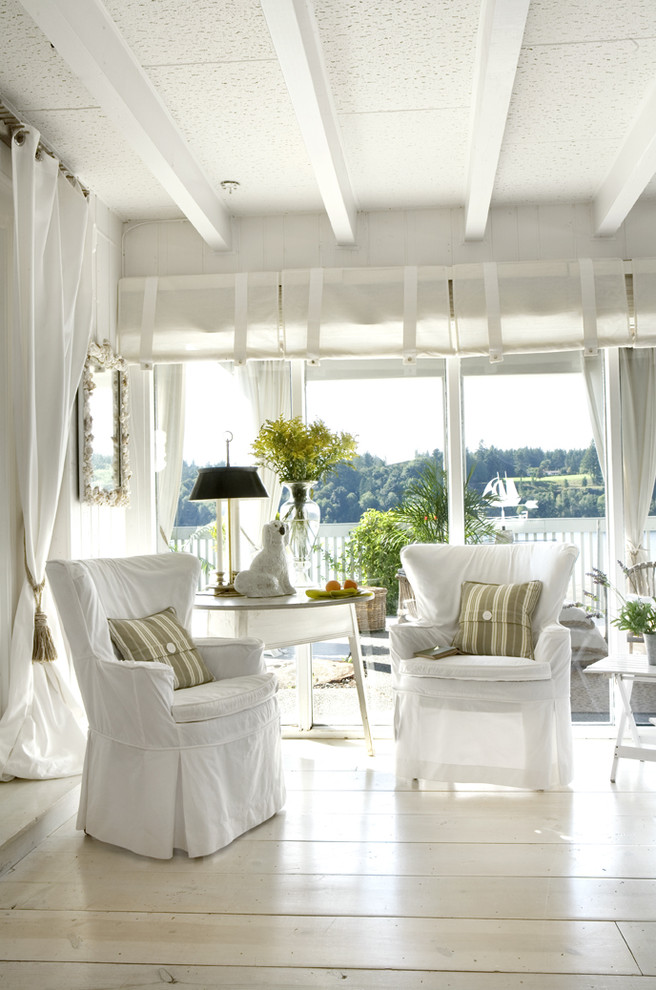 Inspiration for a contemporary light wood floor and white floor living room remodel in Portland with white walls