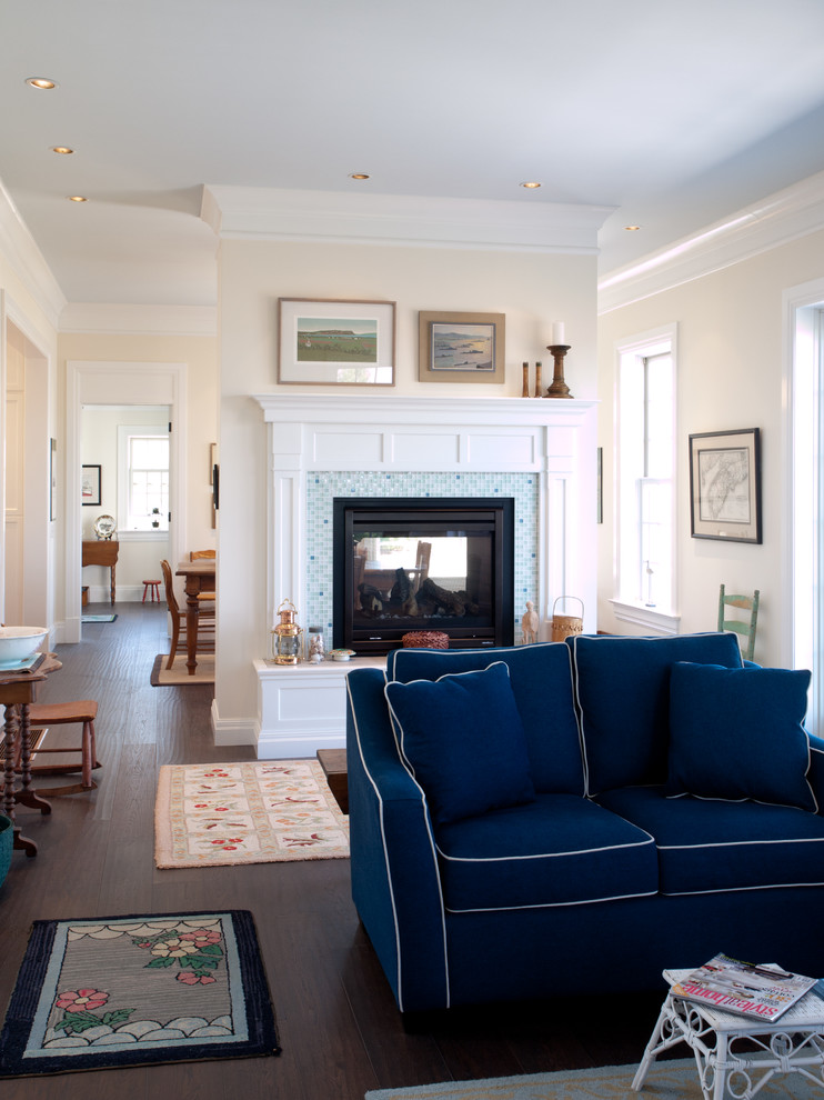 Example of a beach style open concept dark wood floor living room design in Other with white walls, a two-sided fireplace and a tile fireplace