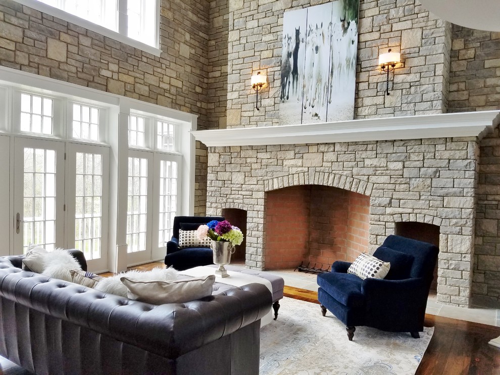 Inspiration for an expansive classic formal open plan living room in Philadelphia with dark hardwood flooring, a stone fireplace surround, no tv, brown walls, a standard fireplace and brown floors.